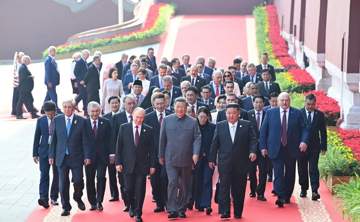 Vladimir Putin, Xi Jinping and Kim Jong Un lead dozens of other world leaders to their seats to watch the parade on Beijing’s Tiananmen Square, 3 September 2025. Photo: Kremlin