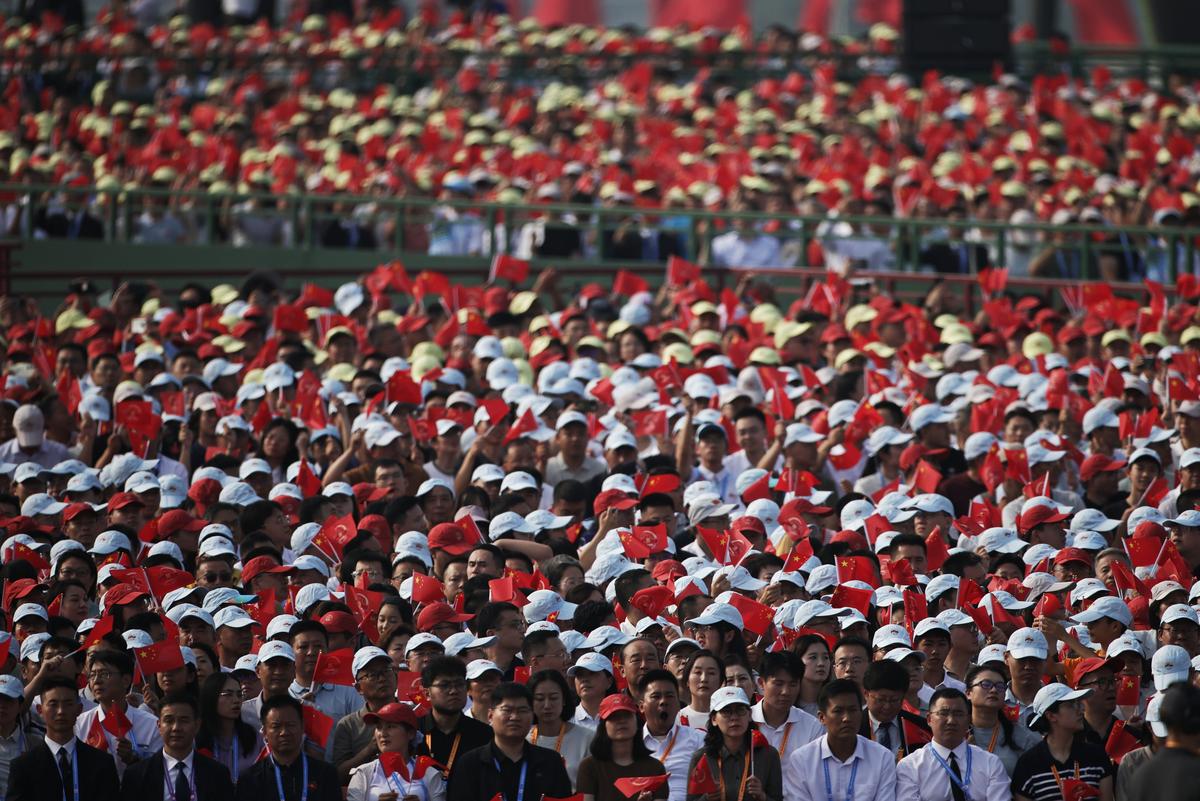 Part of the 50,000-person strong crowd watching the parade. Photo: EPA/WU HAO