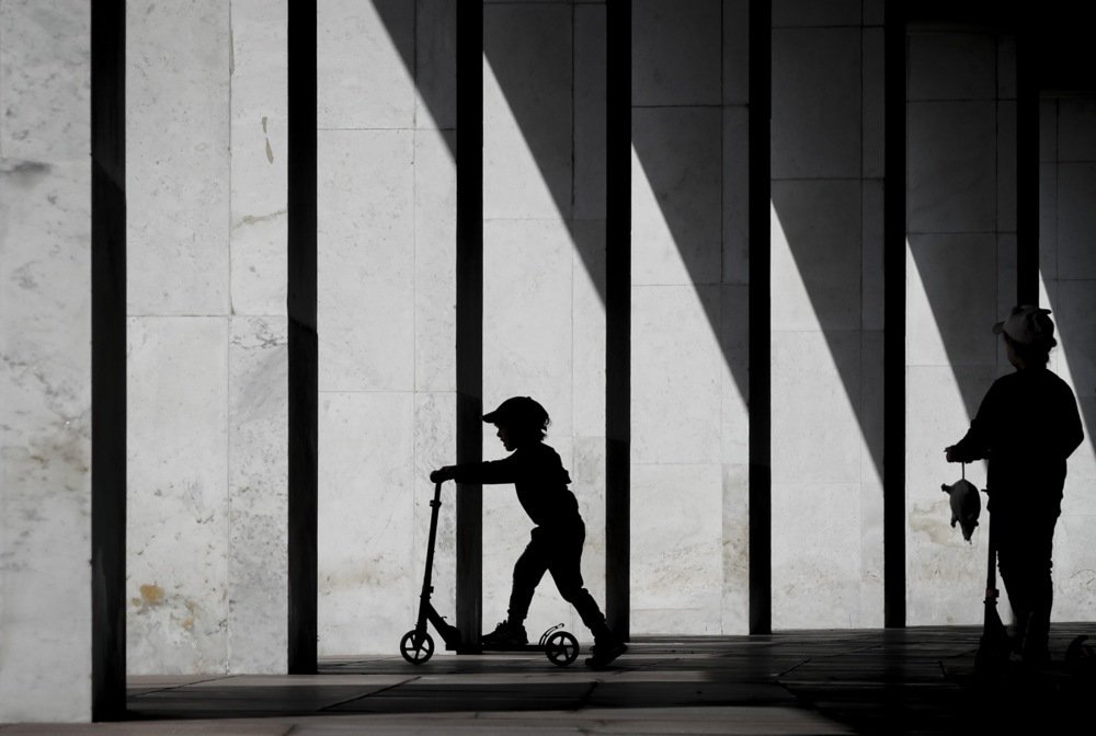 A child rides a scooter in the colonnade of the Victory Museum at Poklonnaya Hill War Memorial Park in Moscow, Russia, 27 August 2023. Photo: EPA-EFE/YURI KOCHETKOV